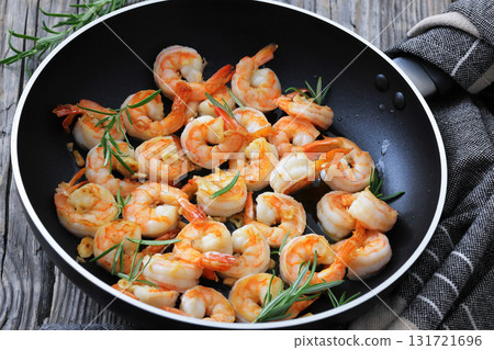 rosemary and garlic seared shrimps in a skillet 131721696