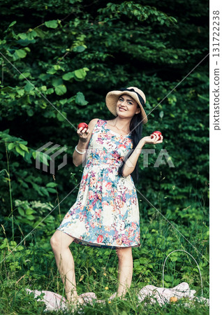 A lady in a hat surrounded by nature 131722238
