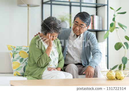 Senior couple worried in the living room Senior couple worried in the living room 131722314