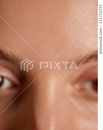 Close-up of smooth forehead and clear skin showing natural texture Close-up of smooth forehead and clear skin showing natural texture 131722315