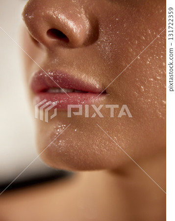 Close-up of wet glossy lips and fresh hydrated skin after skincare treatment Close-up of wet glossy lips and fresh hydrated skin after skincare treatment 131722359