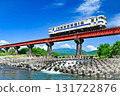 A diesel railcar on the Nichinan Line crossing a railway bridge 131722876