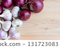 garlic and red onion lying on a wooden background, autumn harvest, copy space 131723083