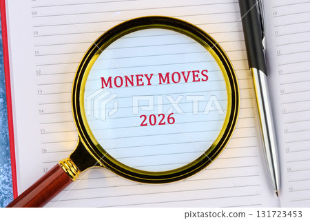 An open agenda displays the words money moves and the year 2026, as seen through a magnifying glass. A pen rests to the right An open agenda displays the words money moves and the year 2026, as seen through a magnifying glass. A pen rests to the right 131723453