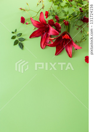 Two large red lilies with red roses on green background 131724156