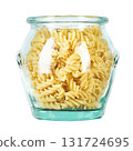 Raw pasta Fusilli in a glass jar isolated on white background.  131724695
