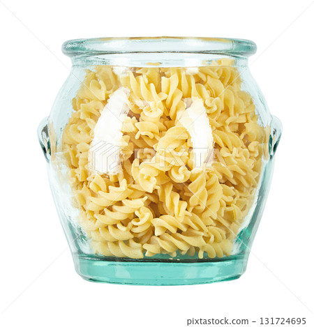 Raw pasta Fusilli in a glass jar isolated on white background. Raw pasta Fusilli in a glass jar isolated on white background. 131724695
