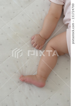 A 0-year-old baby taking a nap on his stomach A 0-year-old baby taking a nap on his stomach 131724700