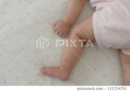 A 0-year-old baby taking a nap on his stomach A 0-year-old baby taking a nap on his stomach 131724701