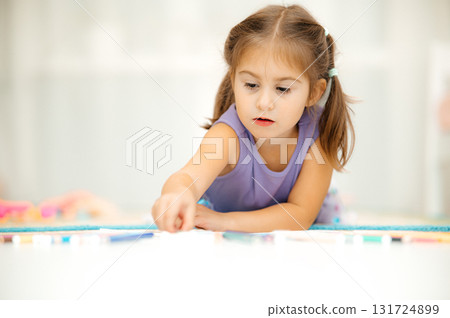 A Young Girl Engaged in Creative Play Using Colorful and Vibrant Materials, Expressing Joy 131724899