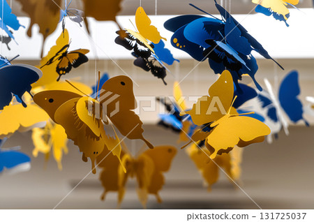 ceiling decorated with decorative colored paper butterflies, selective focus, blurred background 131725037