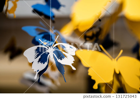 ceiling decorated with decorative colored paper butterflies, selective focus, blurred background 131725043