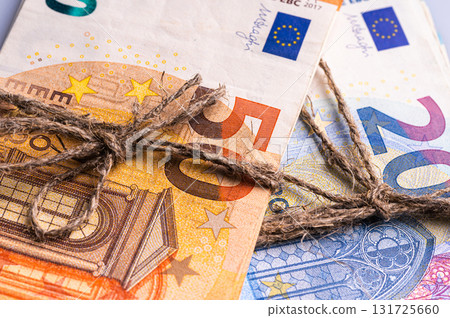 stack of euro banknotes tied with burlap string, close-up, wealth and prosperity concept stack of euro banknotes tied with burlap string, close-up, wealth and prosperity concept 131725660