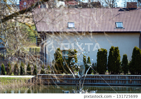 private house with a pond and a fountain, closeup fragment 131725699