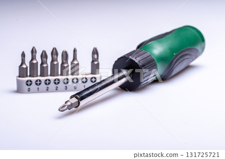 Interchangeable screwdriver set with different types of metal steel heads and bits, closeup Interchangeable screwdriver set with different types of metal steel heads and bits, closeup 131725721