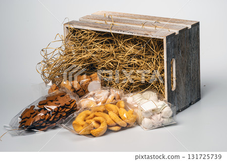 wooden box with straw and a set of different cookies, isolated, copy space, closeup 131725739