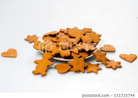 freshly baked gingerbread on a white plate, isolated on white, copy space, closeup freshly baked gingerbread on a white plate, isolated on white, copy space, closeup 131725744