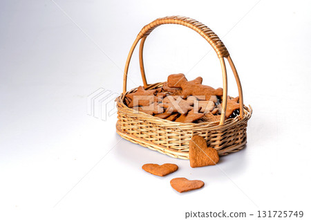 wicker basket with gingerbread, selective focus, closeup, isolated, copy space wicker basket with gingerbread, selective focus, closeup, isolated, copy space 131725749