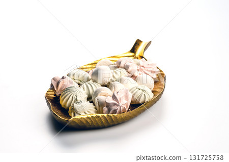 decorative dish with meringue cookies from egg whites, selective focus, closeup, copy space decorative dish with meringue cookies from egg whites, selective focus, closeup, copy space 131725758