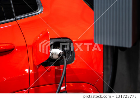 electric car connected to the charger, eco friendly technology, charging an electric car battery 131725775