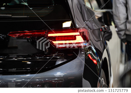 closeup of a red led taillight on a modern car, detail on the rear light of a car 131725779