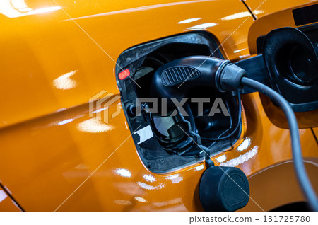 electric car connected to the charger, eco friendly technology, charging an electric car battery electric car connected to the charger, eco friendly technology, charging an electric car battery 131725780