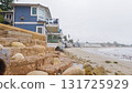 Walking along the shore of Miramar Beach, California, the overcast winter sky creates a tranquil and reflective atmosphere. 131725929
