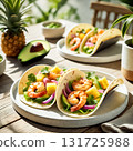 Shrimp tacos filled with grilled shrimp, avocado slices, pineapple chunks, red onions, and cilantro, served on a sleek dining table with bright natural lighting and minimalist decor. The scene exudes 131725988