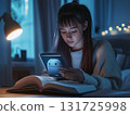 Young girl studies at night with an open book and a glowing digital assistant on her tablet. Ideal for themes on education, AI in learning, or teen study habits. 131725998