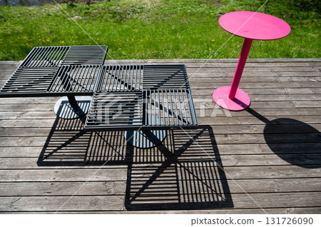 colorful metal benches and tables on the terrace on a sunny summer day colorful metal benches and tables on the terrace on a sunny summer day 131726090