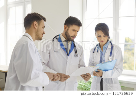 Medical gathering talk, council of physicians, doctors discussion using paper documents, sharing Medical gathering talk, council of physicians, doctors discussion using paper documents, sharing 131726639