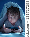 Child using smartphone in bed late at night 131727298