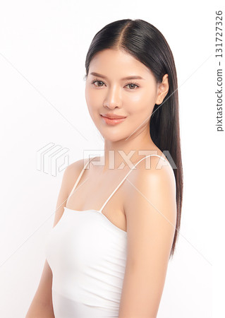 A beautiful young Asian woman with clean, fresh skin against a white background. Skincare, facial treatment, cosmetology, beauty, and spa. An elegant portrait of an Asian woman. 131727326