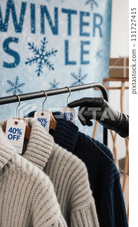 Gloved Hands Browsing Winter Sweaters Under WINTER SALE Banner 131727415