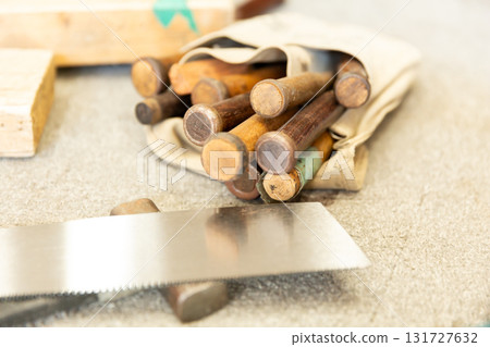 A bag containing well-used carpenter's chisels 131727632