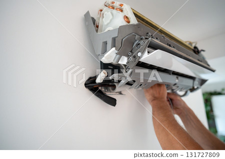 Damaged insulation on copper pipe of indoor air conditioner unit causing water leakage down wall Damaged insulation on copper pipe of indoor air conditioner unit causing water leakage down wall 131727809