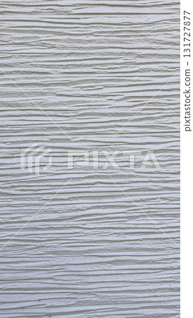 Textured white wall displaying fine lines and grooves in natural lighting at a contemporary setting 131727877