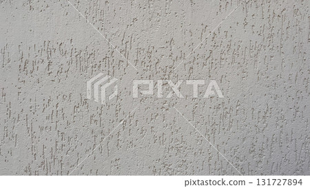 Textured gray wall with faint lines and patterns, reflecting light subtly at different angles Textured gray wall with faint lines and patterns, reflecting light subtly at different angles 131727894