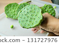 Hand Holding Fresh Lotus Seed Pods for Snack 131727976