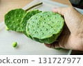 Hand Holding Fresh Lotus Seed Pods for Snack 131727977