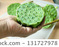 Hand Holding Fresh Lotus Seed Pods for Snack 131727978