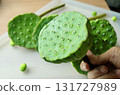 Hand Holding Fresh Edible Lotus Seed Pods 131727989