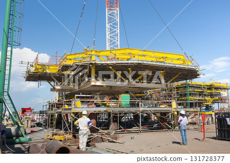 Heavy crane in oil rig construction work. Heavy crane in oil rig construction work. 131728377