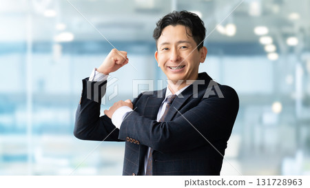 Male businessman doing guts pose Male businessman doing guts pose 131728963