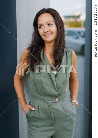 Smiling Millennial Woman In Green Outfit 131729175