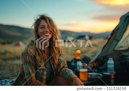 Young Woman Enjoying A Picnic At Sunset 131729239