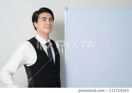 A man thinking in front of a whiteboard A man thinking in front of a whiteboard 131729263