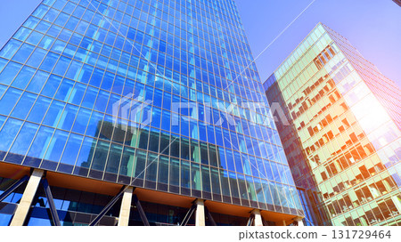 Bottom up view of modern glass office building. Commercial real estate. New commercial office building in modern city. Bottom up view of modern glass office building. Commercial real estate. New commercial office building in modern city. 131729464