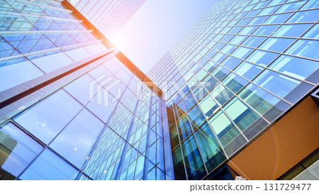 Bottom up view of modern glass office building. Commercial real estate. New commercial office building in modern city. Bottom up view of modern glass office building. Commercial real estate. New commercial office building in modern city. 131729477