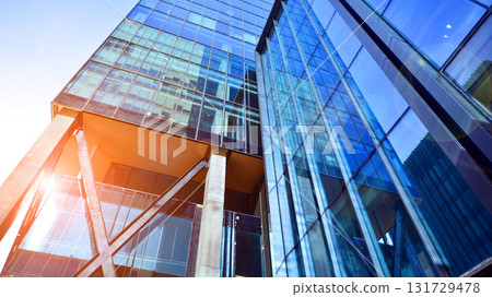 Bottom up view of modern glass office building. Commercial real estate. New commercial office building in modern city. Bottom up view of modern glass office building. Commercial real estate. New commercial office building in modern city. 131729478